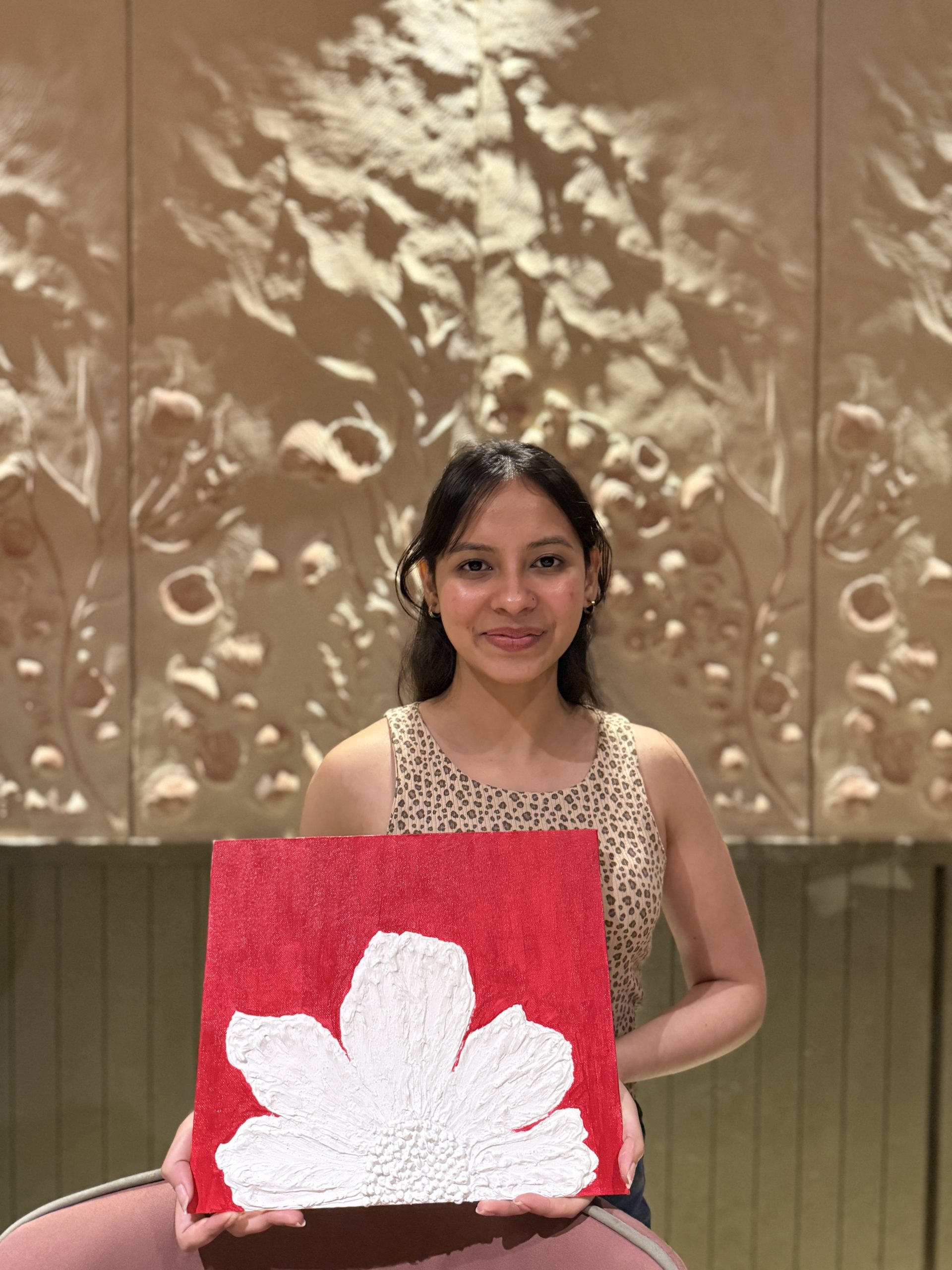 A member mid-brushstroke at an Art Nexus paint night
